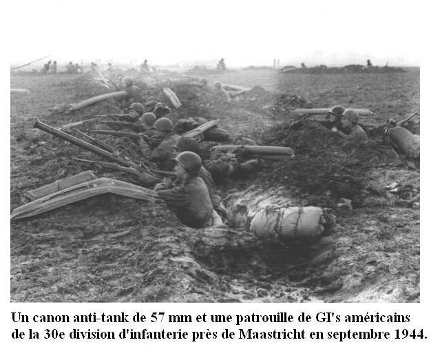 A 57mm anti-tank gun and a patrol of American GI's from the 30th Infantry Division